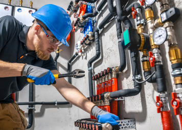 Plumbing contractor in Dubai inspecting pipe systems at a commercial property